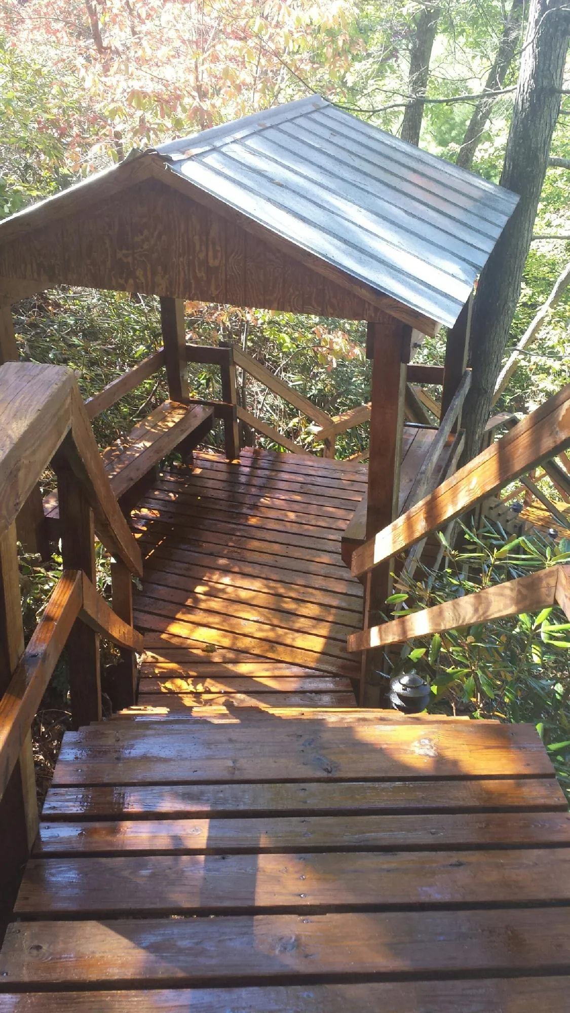 Freshly stained wood walkway and covered shelter with a metal roof in Nebo